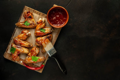 grilled chicken wings in a barbecue sauce with parsley